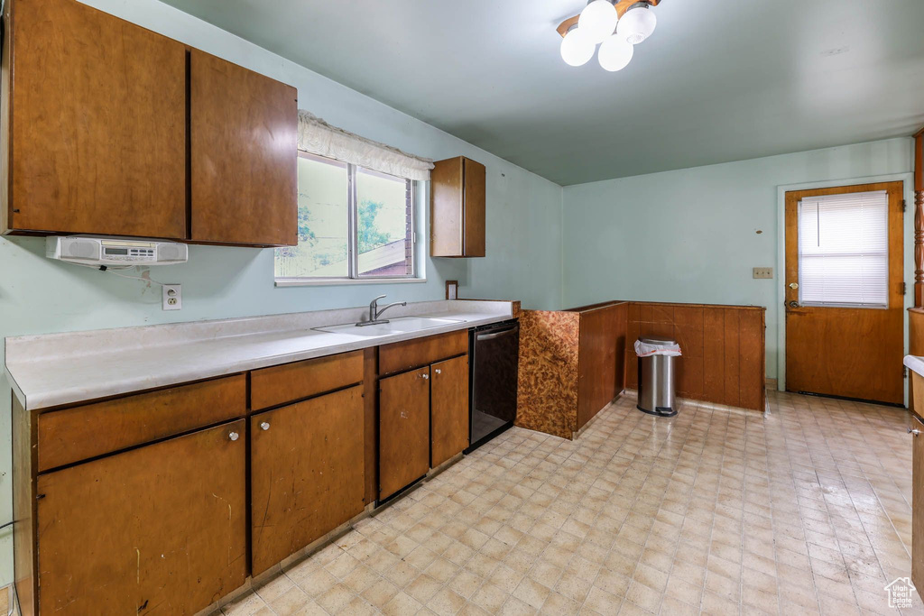 Kitchen with dishwasher, light countertops, plenty of natural light, and a sink