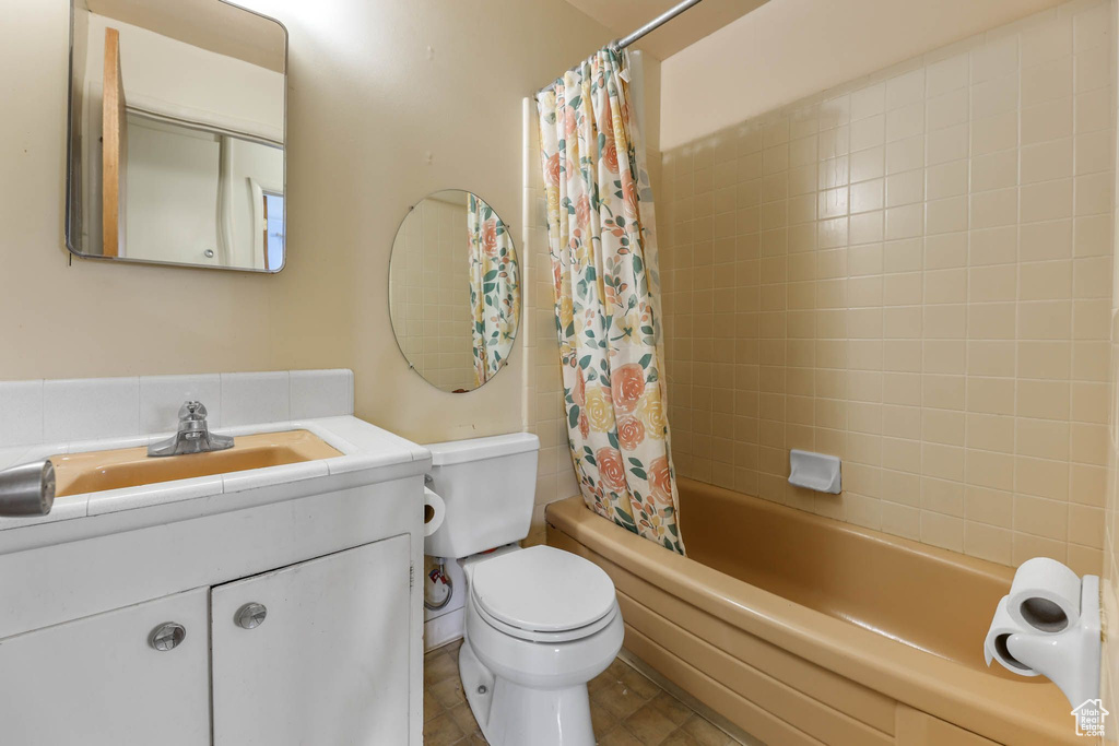 Full bath with toilet, shower / tub combo, and vanity