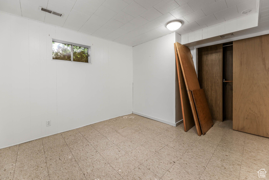 Below grade area with tile patterned floors and elevator