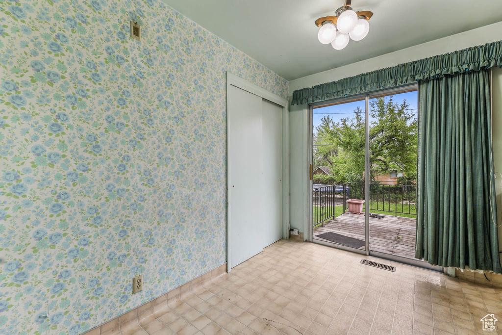 Spare room featuring wallpapered walls