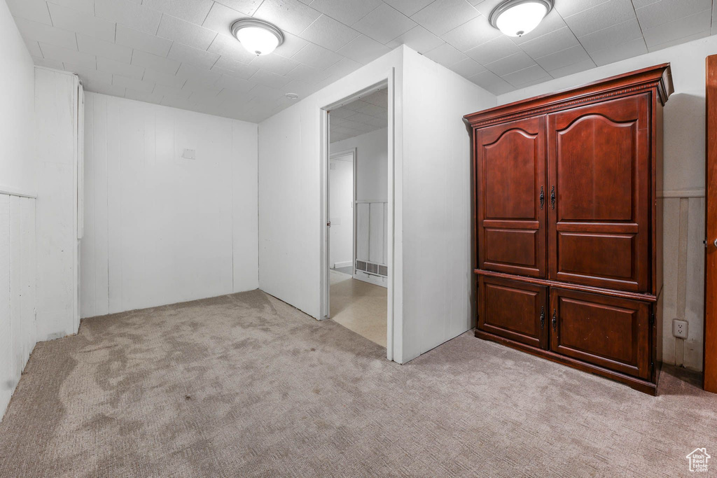 Unfurnished bedroom featuring light colored carpet