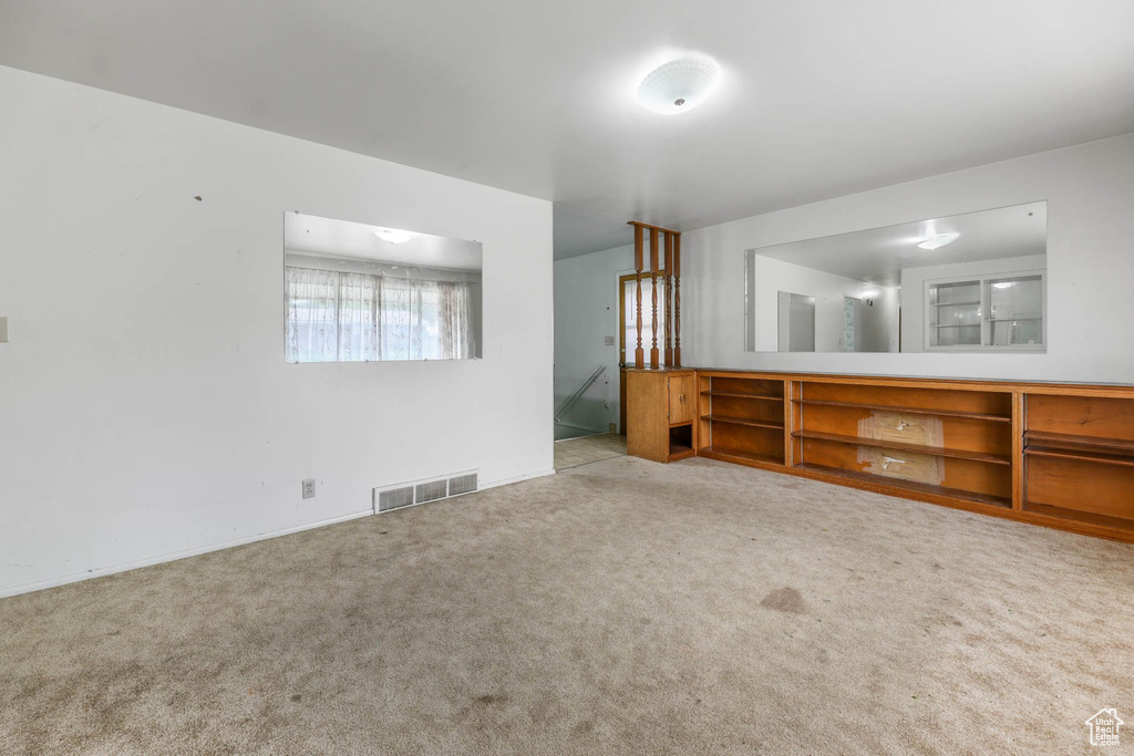 Spare room with carpet and baseboards