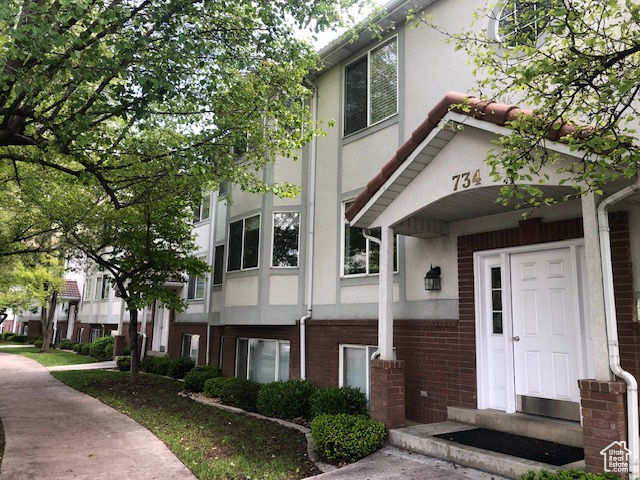 View of front of property featuring stucco siding and brick siding