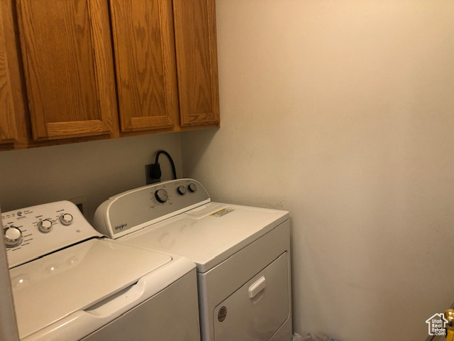 Laundry room with cabinet space and separate washer and dryer