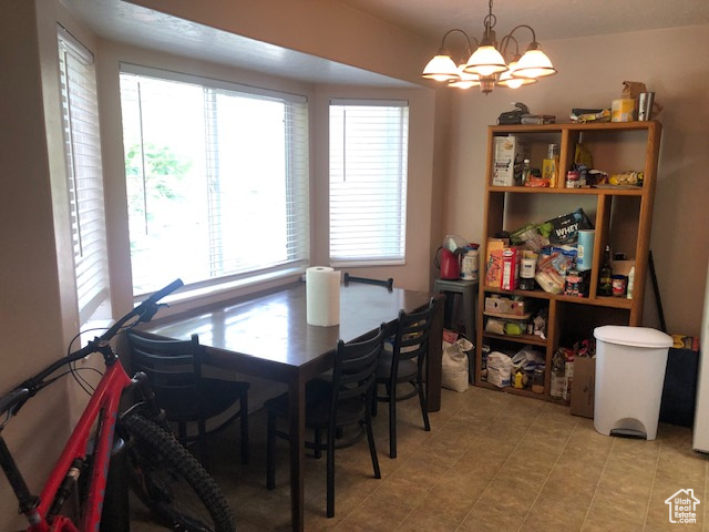 Dining area featuring a chandelier and light tile patterned floors