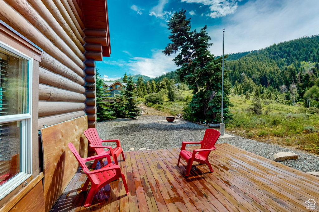 Wooden terrace featuring a view of trees