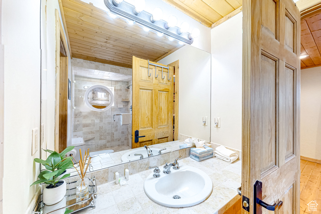 Bathroom featuring wooden ceiling and vanity