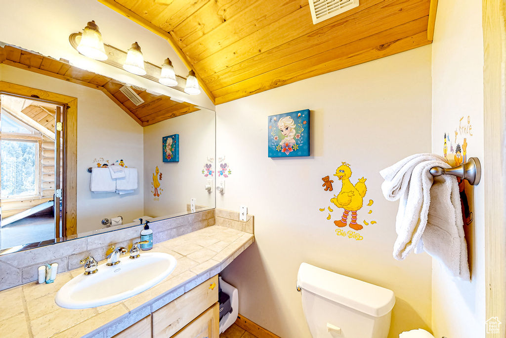 Half bath with vaulted ceiling, wooden ceiling, toilet, and vanity