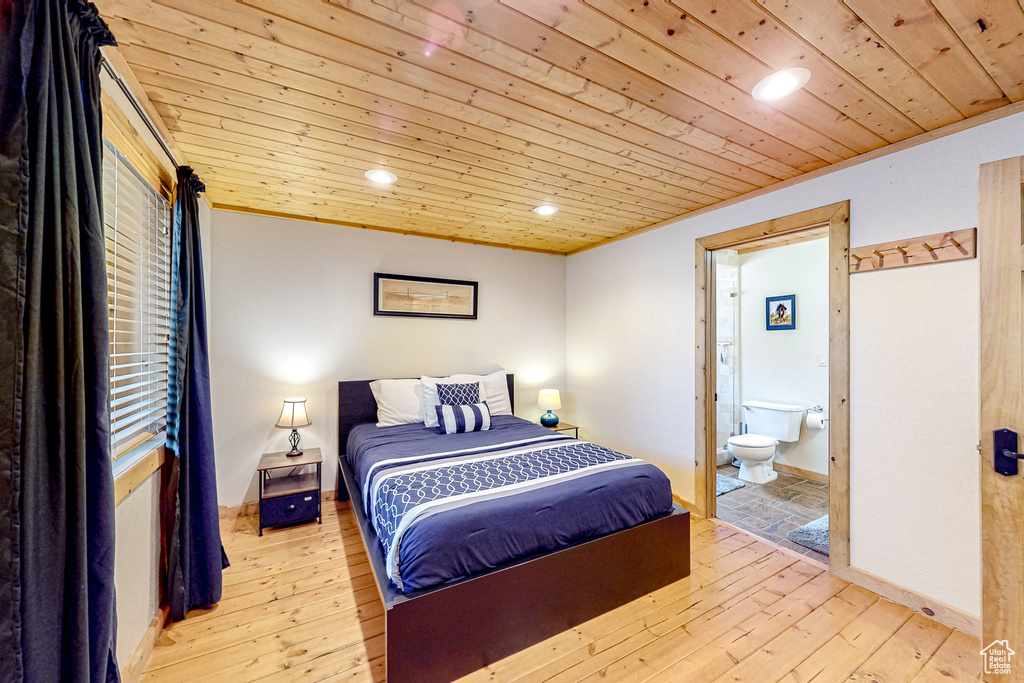 Bedroom featuring wooden ceiling, recessed lighting, hardwood / wood-style flooring, ensuite bath, and baseboards