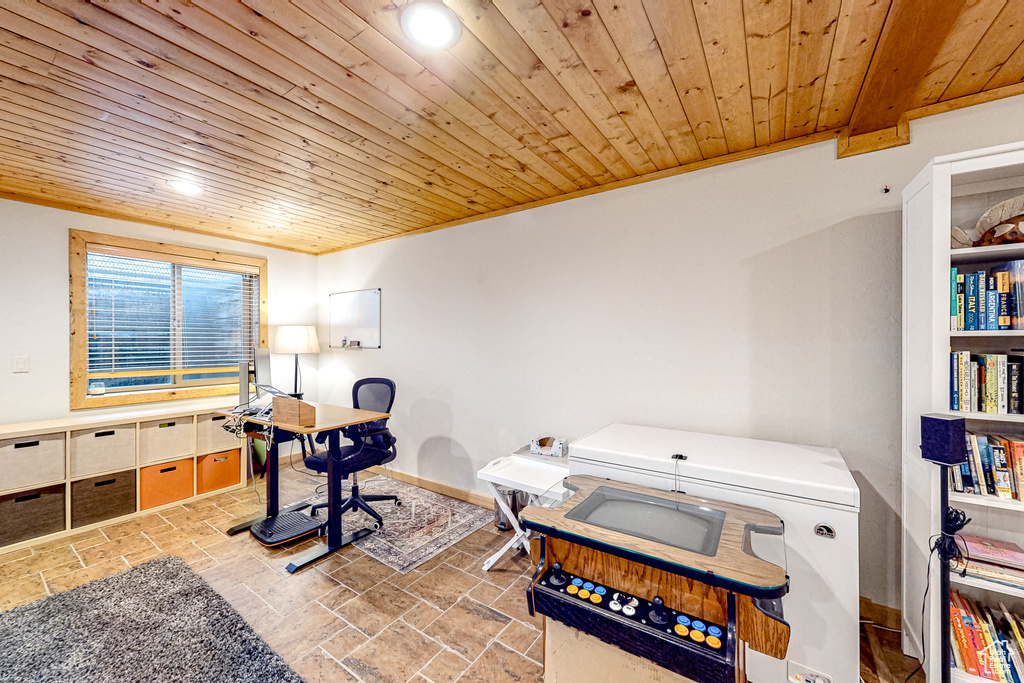Office space with wood ceiling, stone tile flooring, recessed lighting, and baseboards