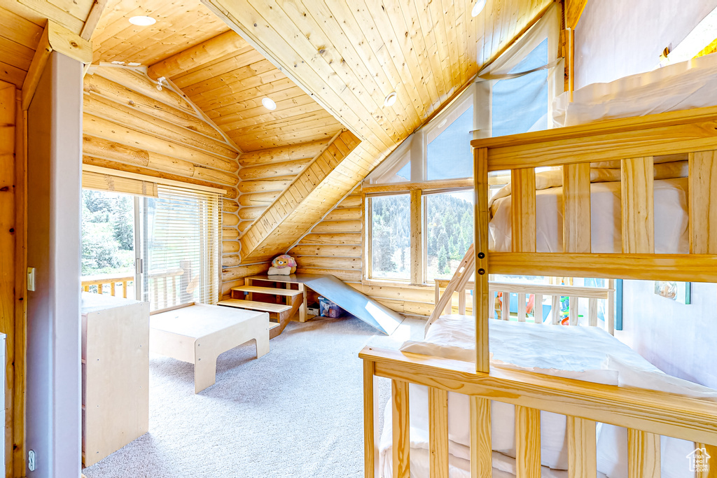 Carpeted bedroom with log walls, wooden ceiling, and recessed lighting