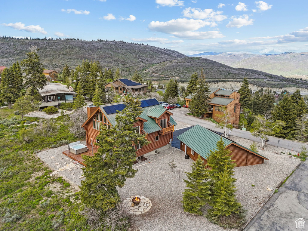 Aerial view of property and surrounding area featuring a mountain backdrop