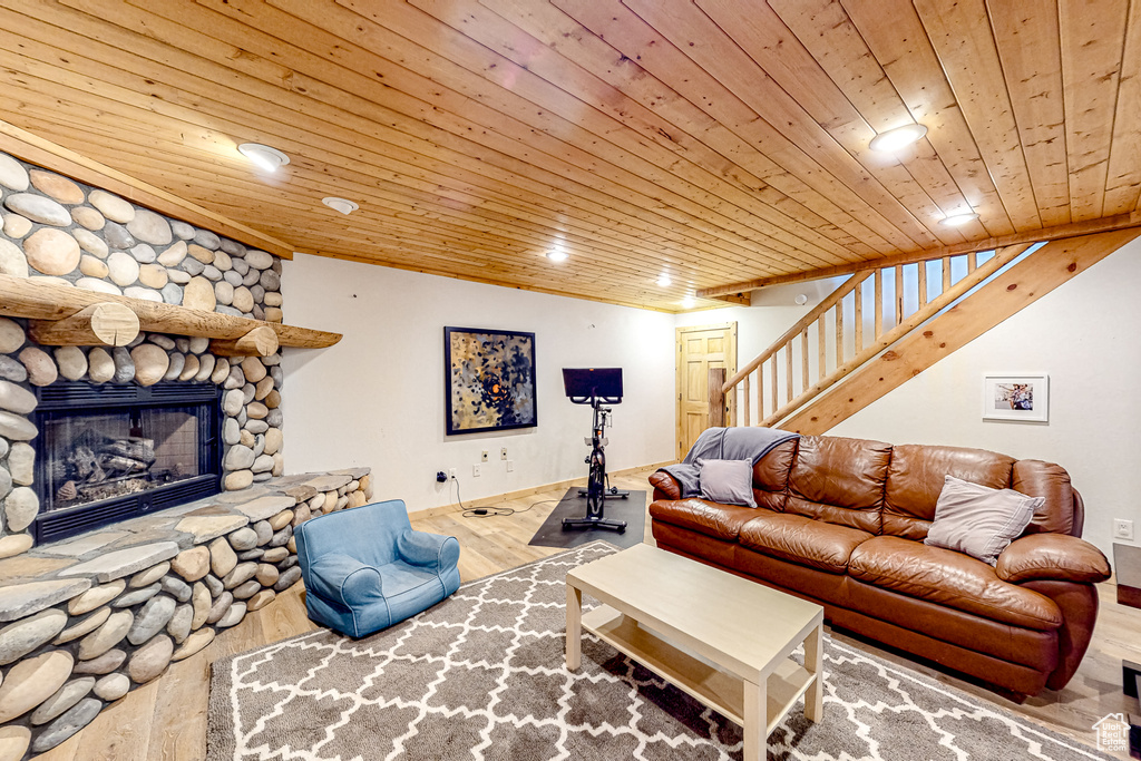 Living room with wood ceiling, wood finished floors, recessed lighting, stairs, and baseboards