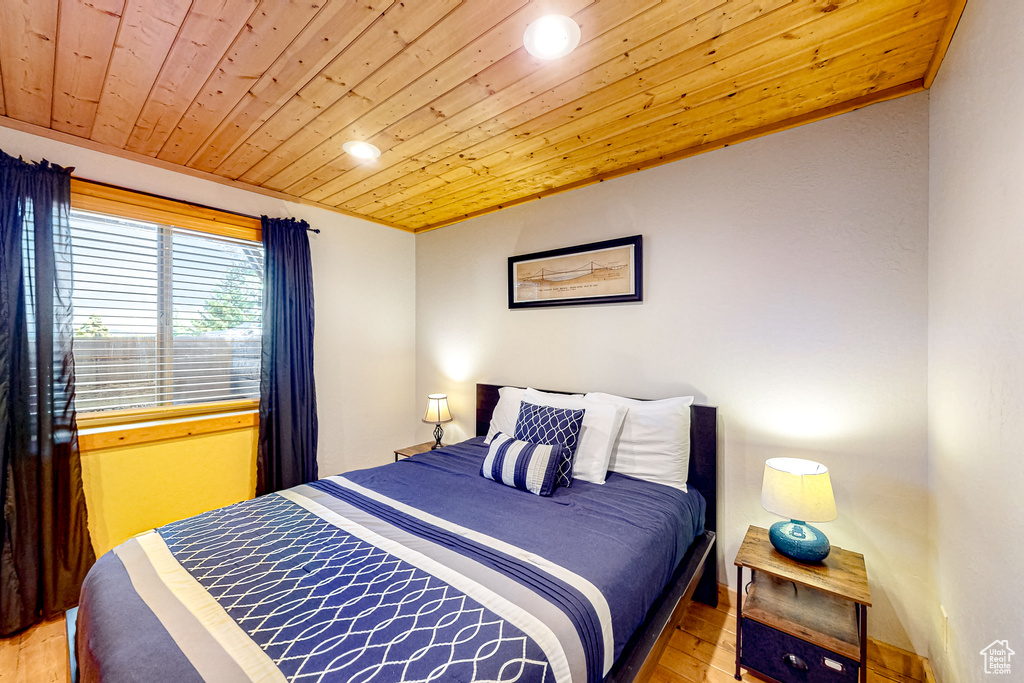 Bedroom featuring wood ceiling, light wood-style flooring, and recessed lighting
