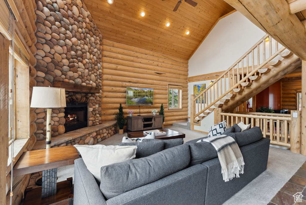 Living area featuring high vaulted ceiling, wood ceiling, a fireplace, recessed lighting, and stairway