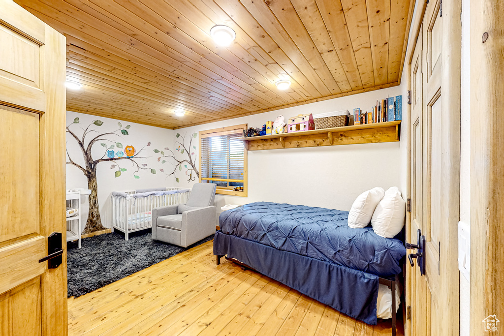Bedroom with wood-type flooring and wood ceiling