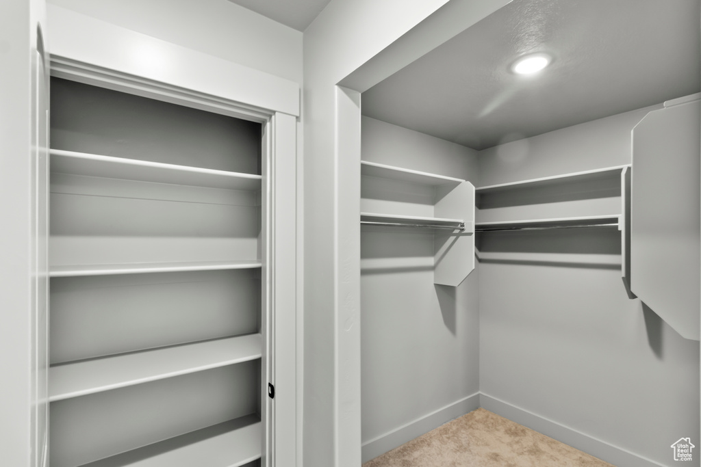 Walk in closet with carpet flooring