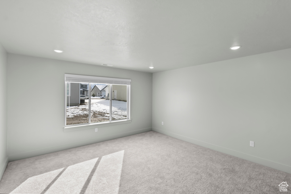 Spare room with carpet flooring, recessed lighting, and baseboards