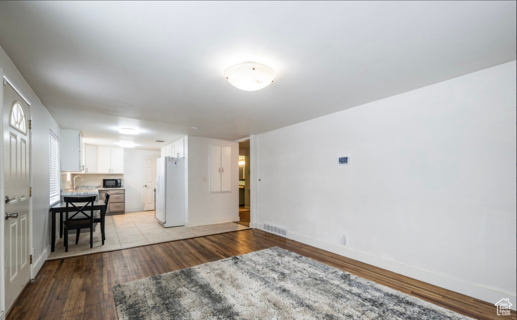 Living room featuring light wood-style floors and baseboards