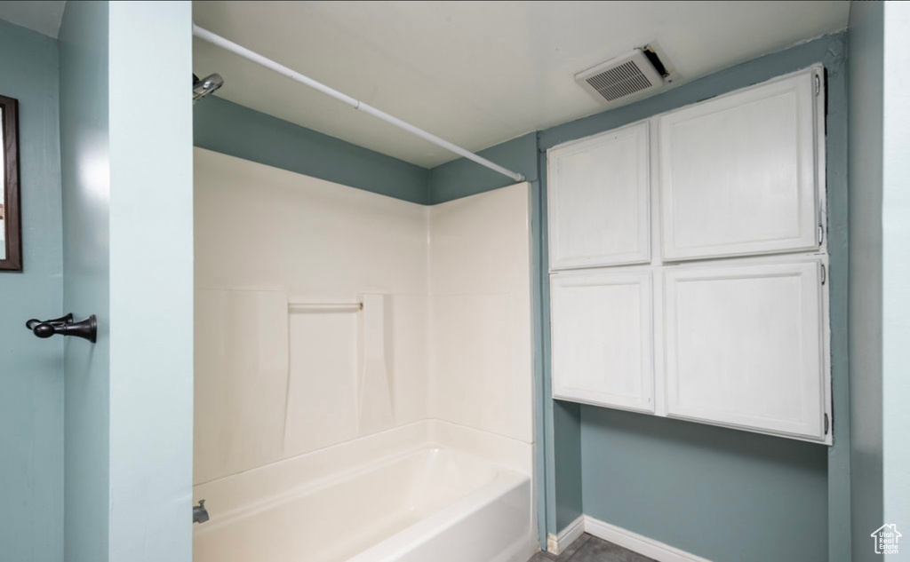 Full bath with washtub / shower combination and baseboards