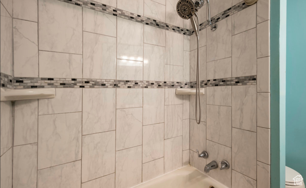 Full bath with tub / shower combination and toilet