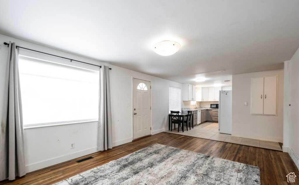 Entryway featuring light wood-type flooring, plenty of natural light, and baseboards
