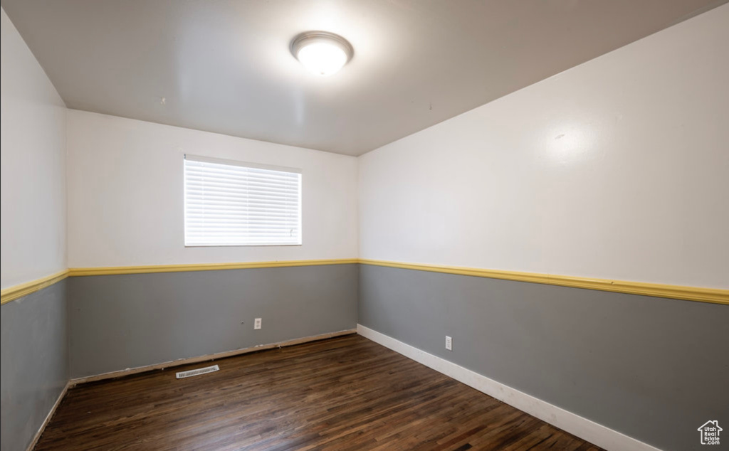 Spare room with wood finished floors and baseboards
