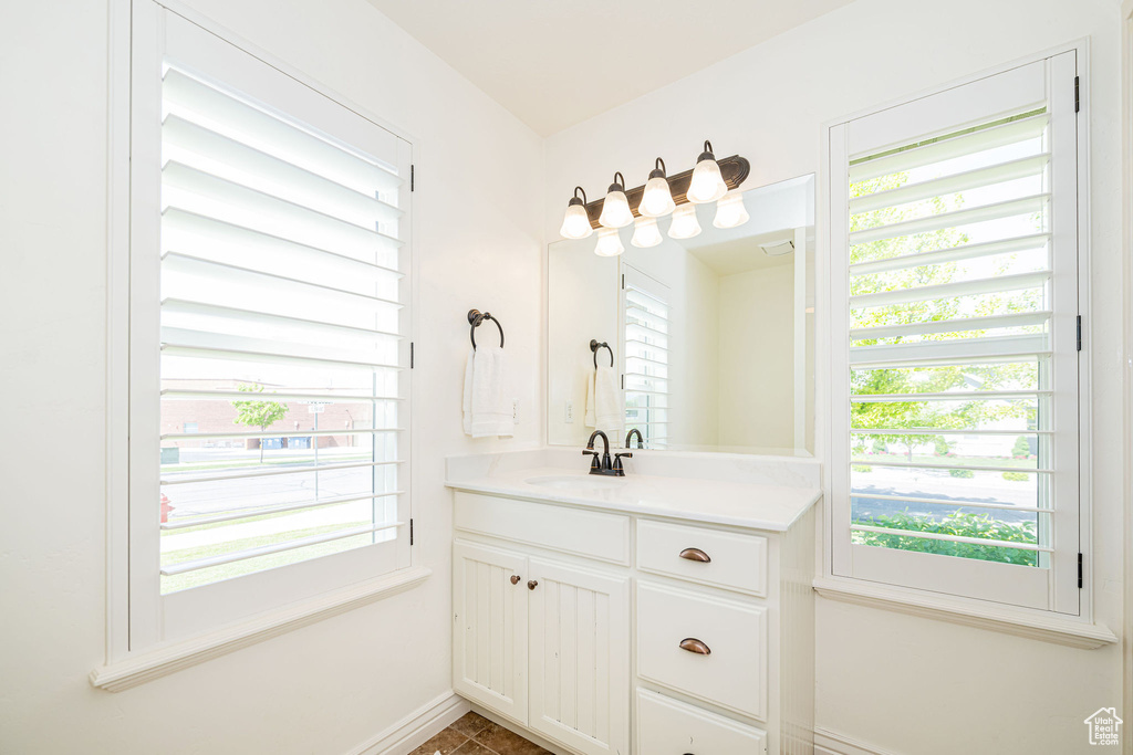 Bathroom with vanity and baseboards