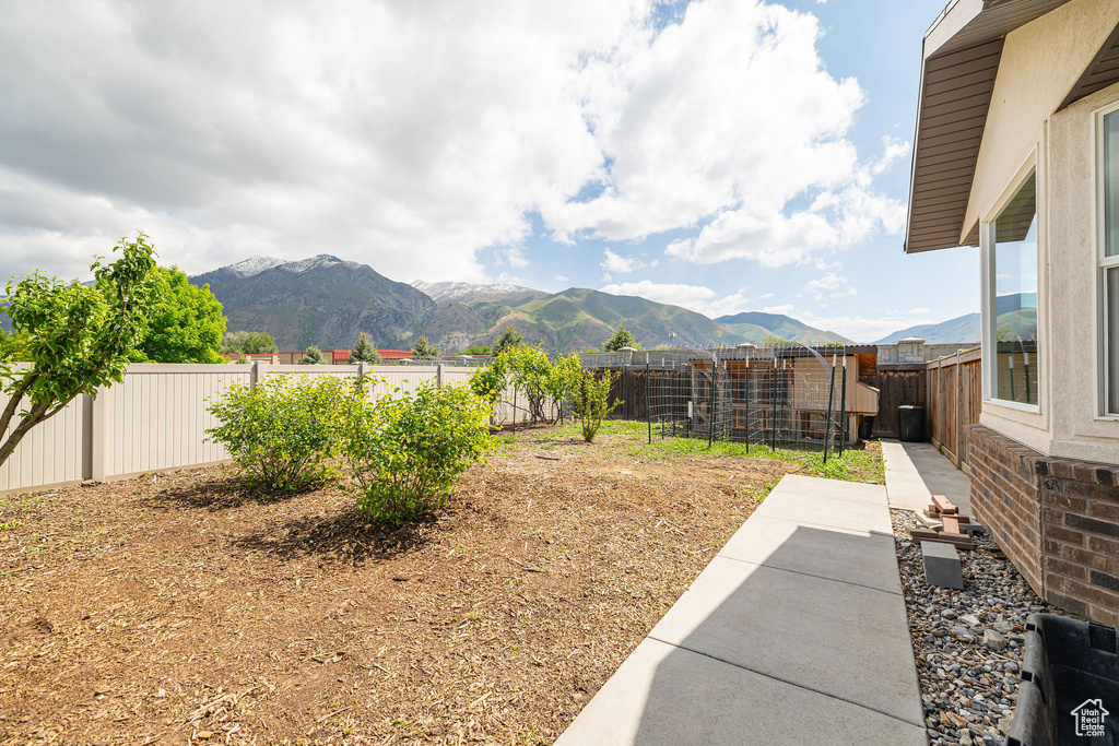 Fenced backyard featuring a mountain view