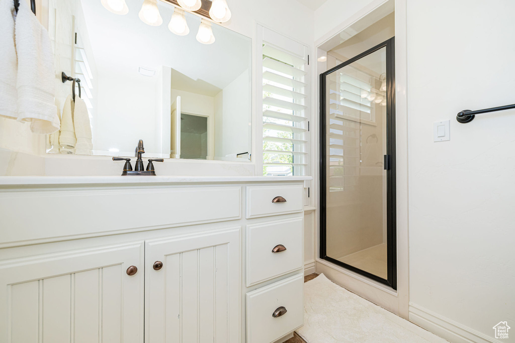 Bathroom featuring a shower stall and vanity