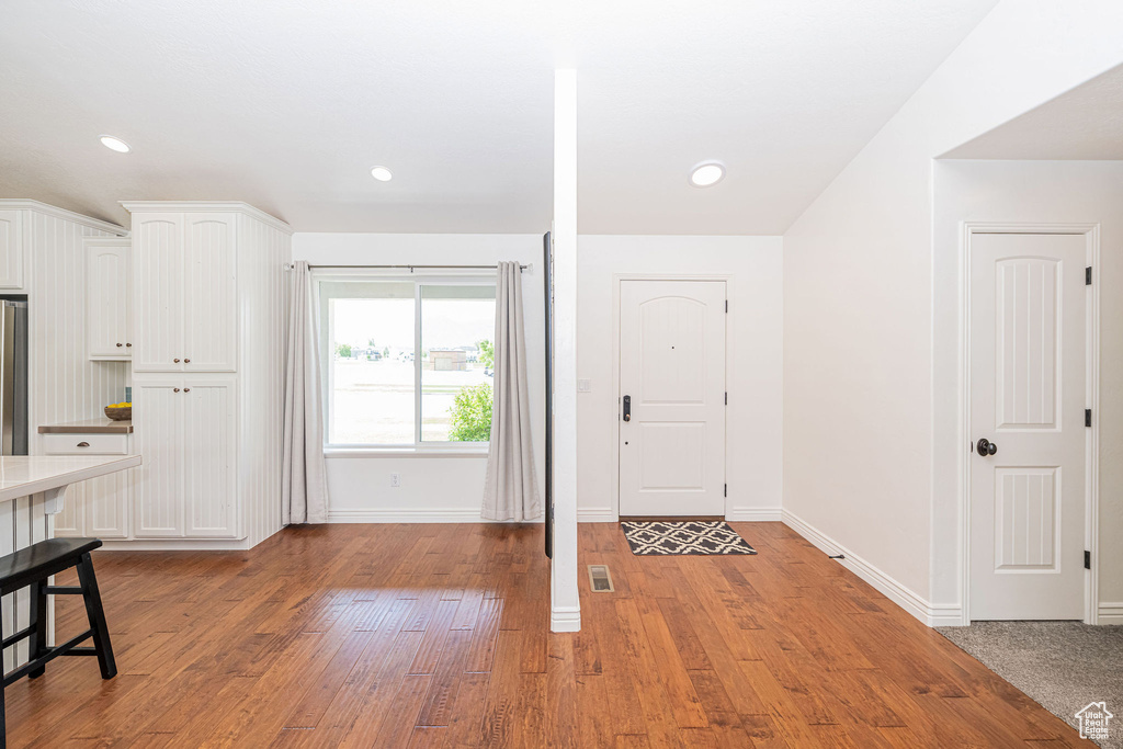 Entryway featuring baseboards and light wood-type flooring
