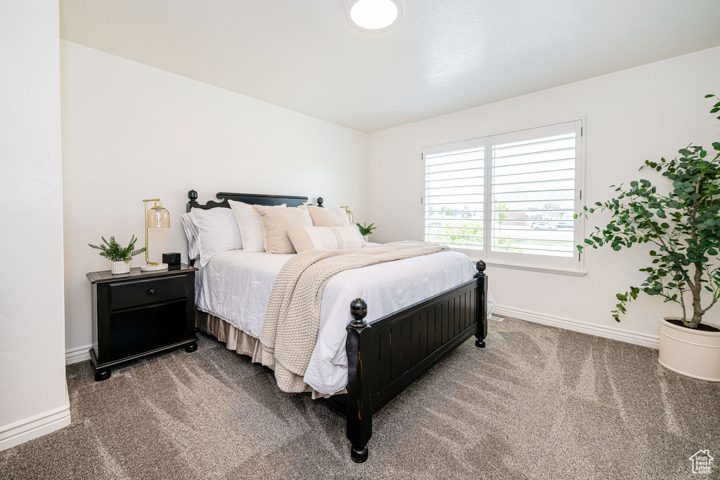 Carpeted bedroom featuring baseboards