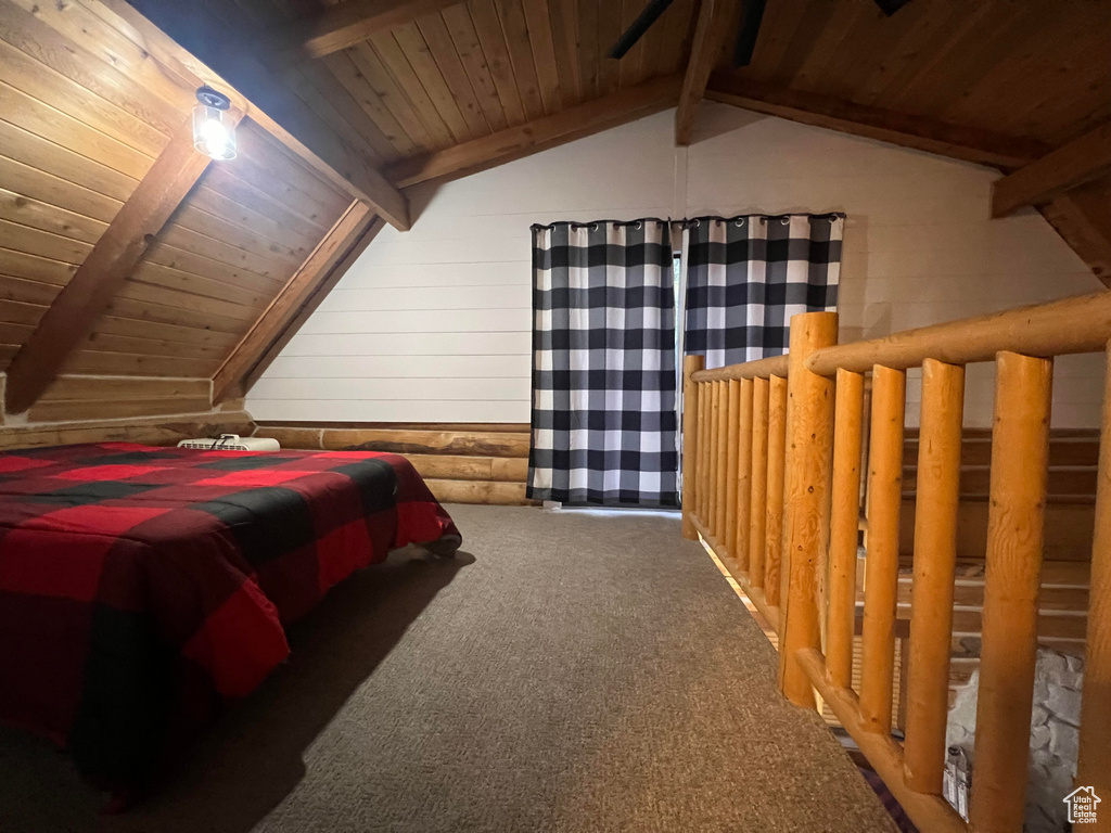 Bedroom featuring wooden ceiling and carpet floors