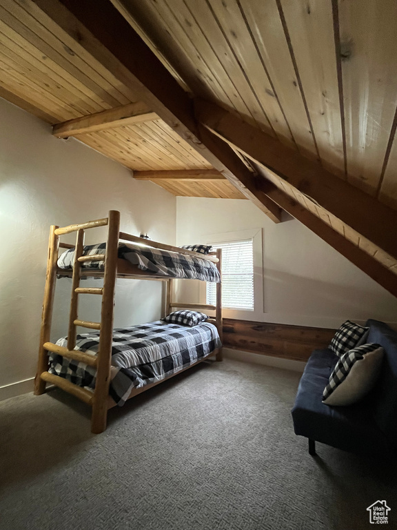 Carpeted bedroom featuring wood ceiling and baseboards