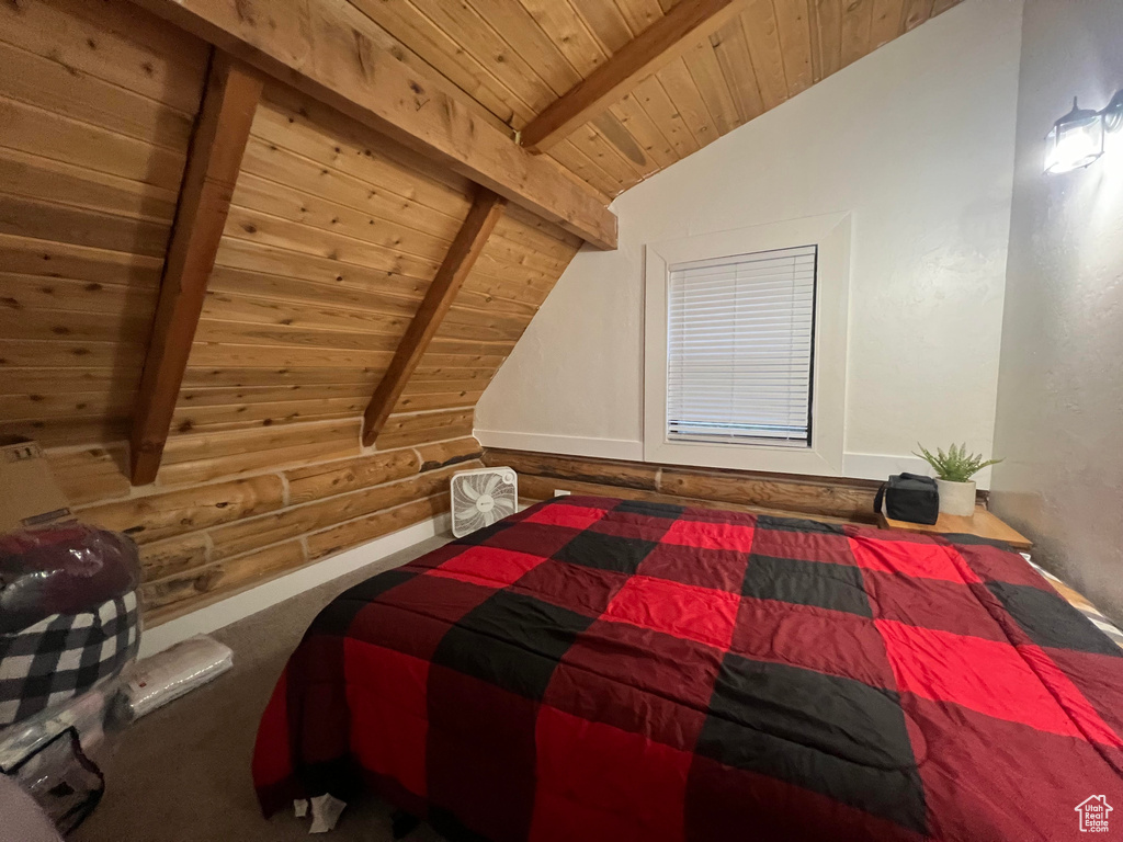Bedroom with wooden ceiling and rustic walls