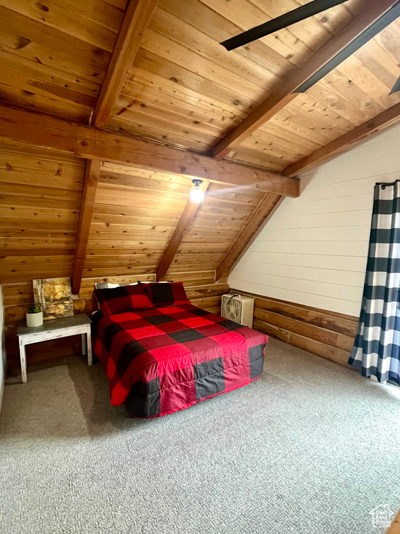Carpeted bedroom with wooden ceiling and wooden walls