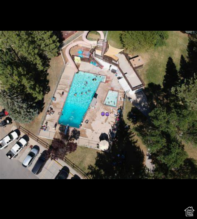 Aerial view of property and surrounding area featuring a pool area