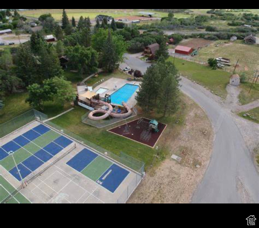 Aerial view of property and surrounding area with a pool area