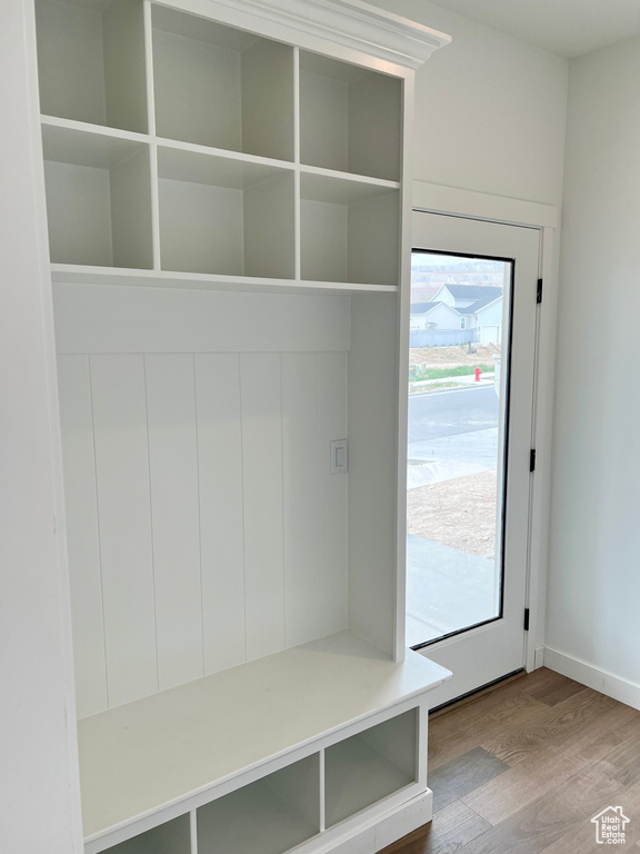Mudroom with wood finished floors and baseboards