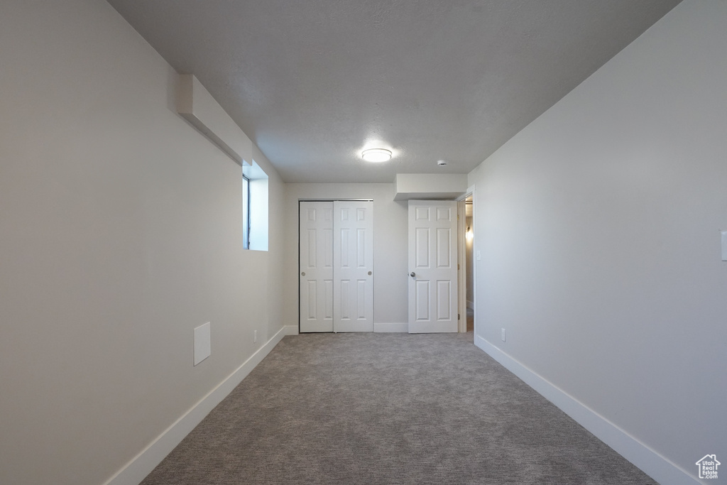 Unfurnished bedroom with carpet, baseboards, and a closet