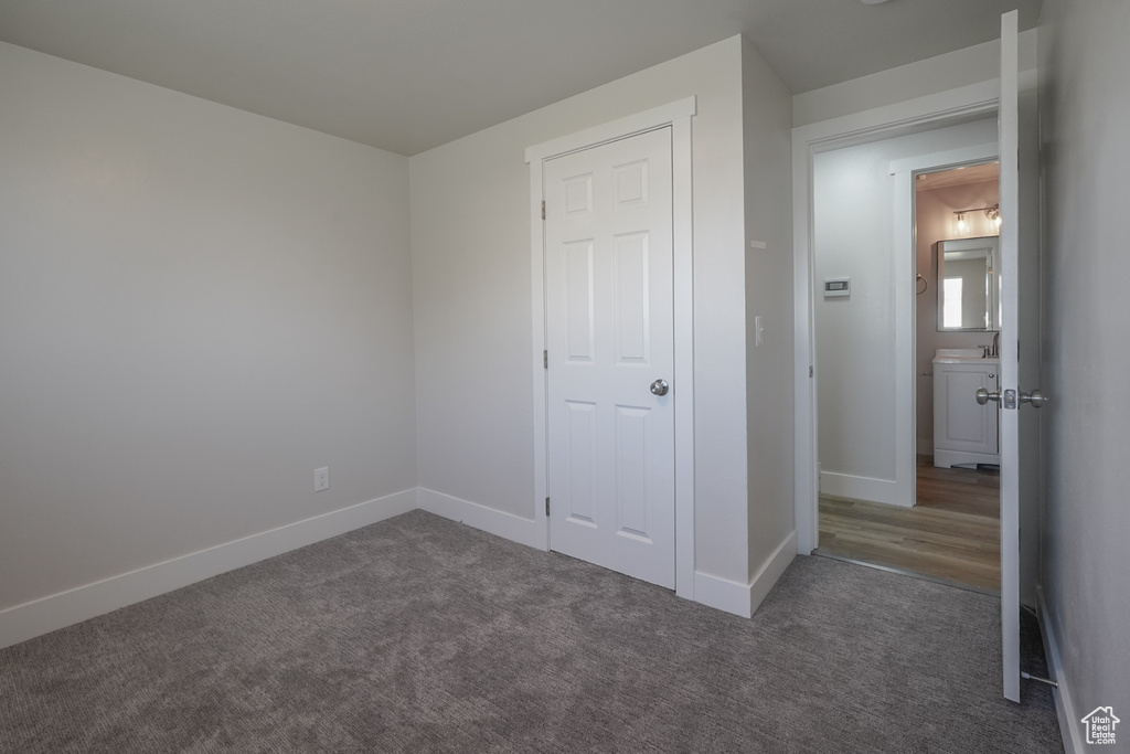 Unfurnished bedroom with baseboards and carpet flooring