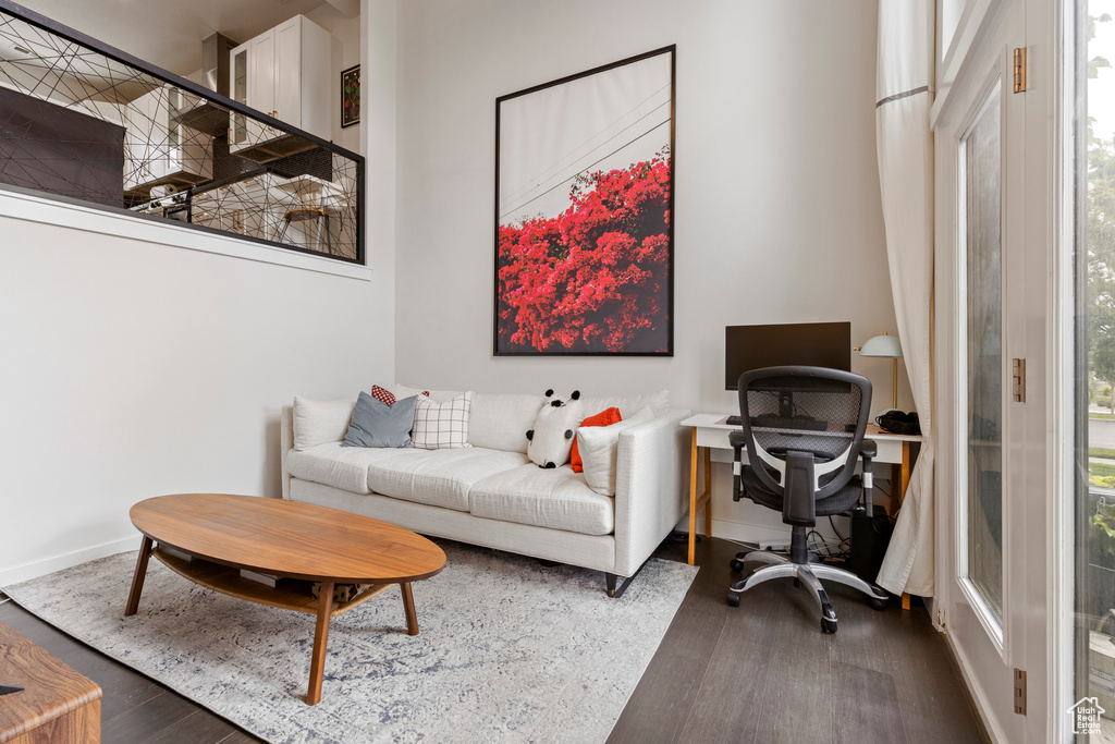 Home office with dark wood finished floors and baseboards