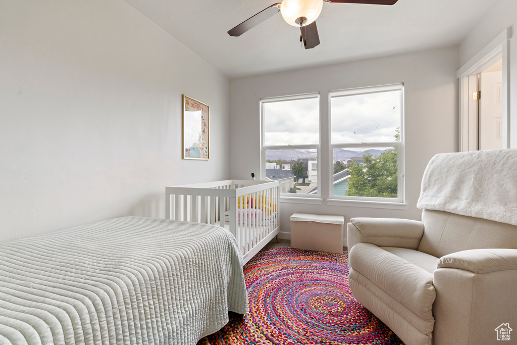 Bedroom with carpet, a ceiling fan, and lofted ceiling