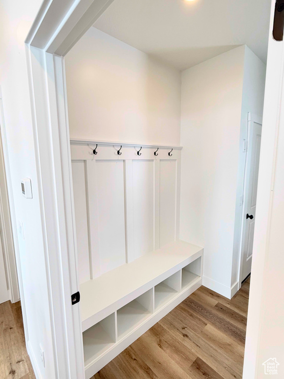 Mudroom with wood finished floors and baseboards