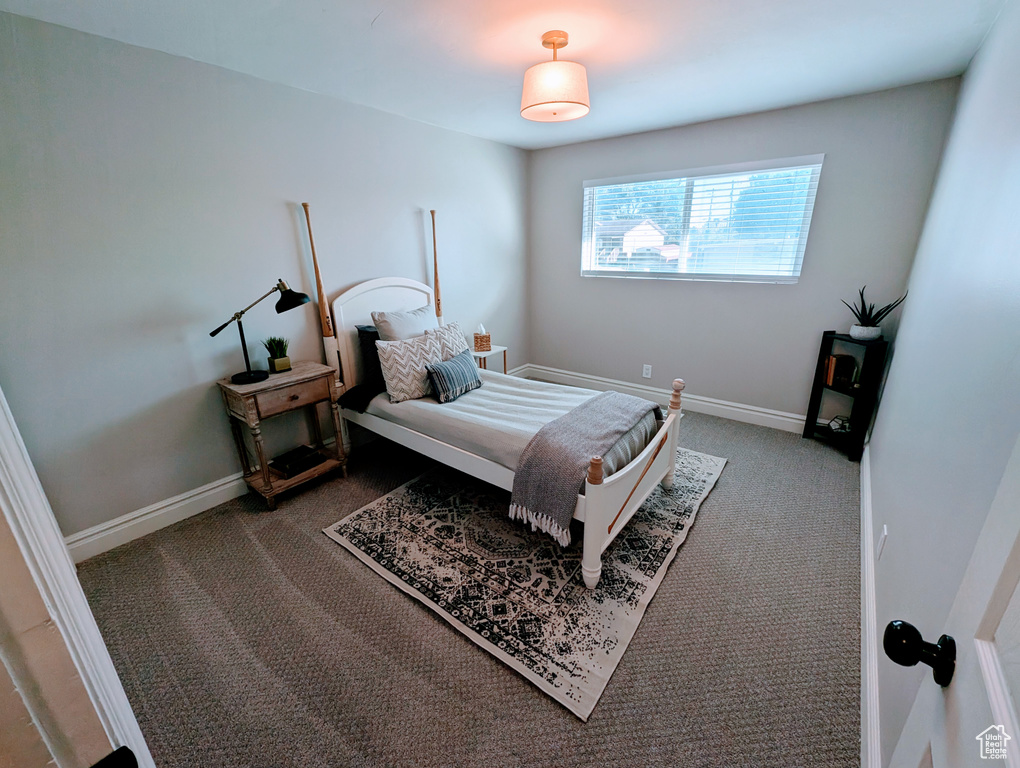 Bedroom featuring carpet floors and baseboards