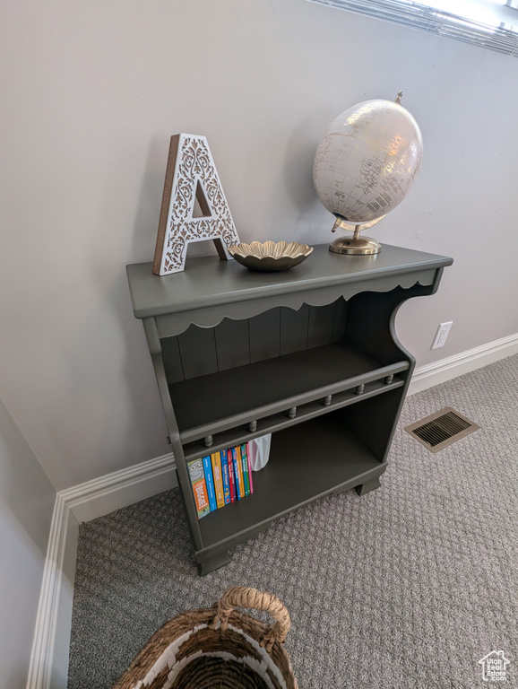 Detailed view of carpet flooring and baseboards