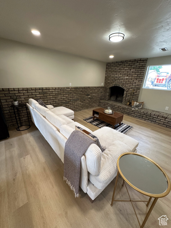 Living area featuring a fireplace, wood finished floors, wainscoting, and recessed lighting