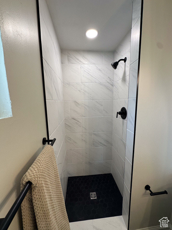 Bathroom with a tile shower and recessed lighting