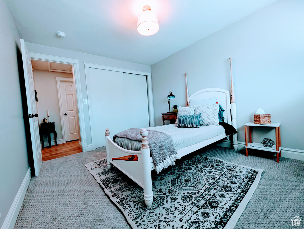 Bedroom featuring carpet, a closet, and baseboards