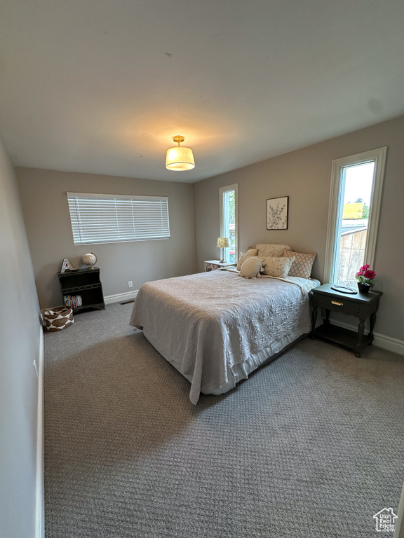 Carpeted bedroom featuring baseboards